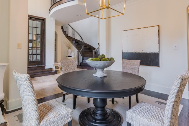 dining space with ornamental molding and a notable chandelier