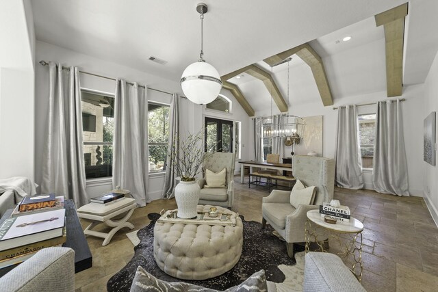 living area featuring an inviting chandelier and lofted ceiling with beams