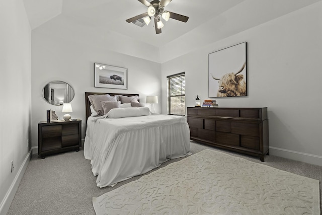 bedroom with lofted ceiling, ceiling fan, and light carpet