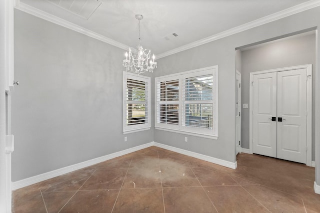 unfurnished dining area with dark tile patterned floors, crown molding, and a chandelier