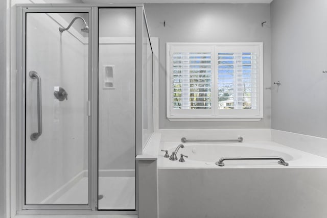 bathroom featuring shower with separate bathtub