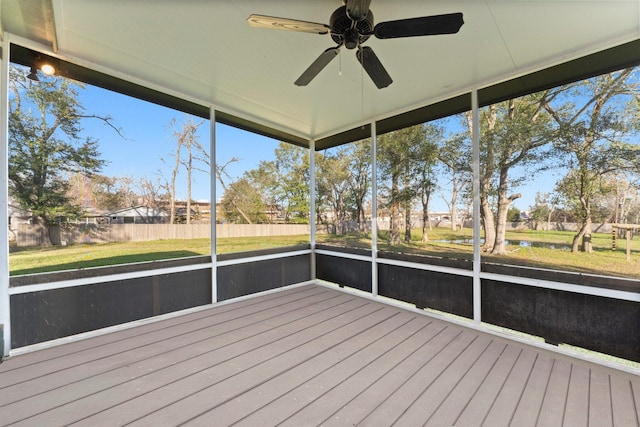 unfurnished sunroom featuring ceiling fan