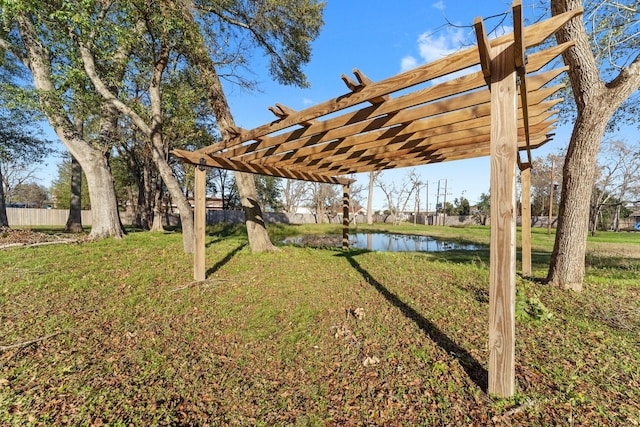 view of yard with a pergola and a water view