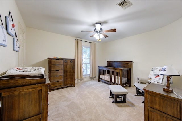 bedroom featuring light carpet and ceiling fan