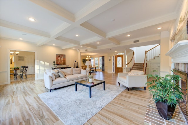 living room with beamed ceiling, a notable chandelier, light hardwood / wood-style floors, and coffered ceiling