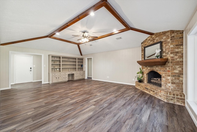 unfurnished living room featuring vaulted ceiling with beams, ceiling fan, built in features, and a fireplace