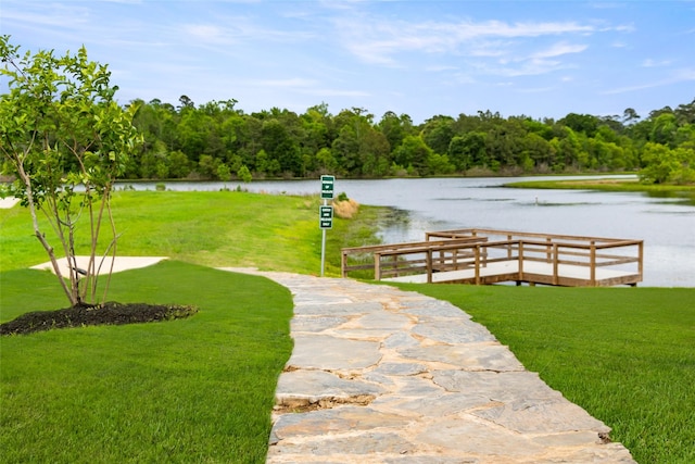 surrounding community featuring a yard and a water view