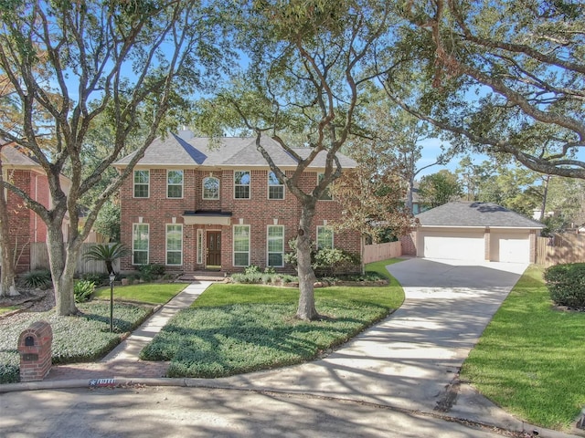 view of front of house with an outbuilding, a front yard, and a garage