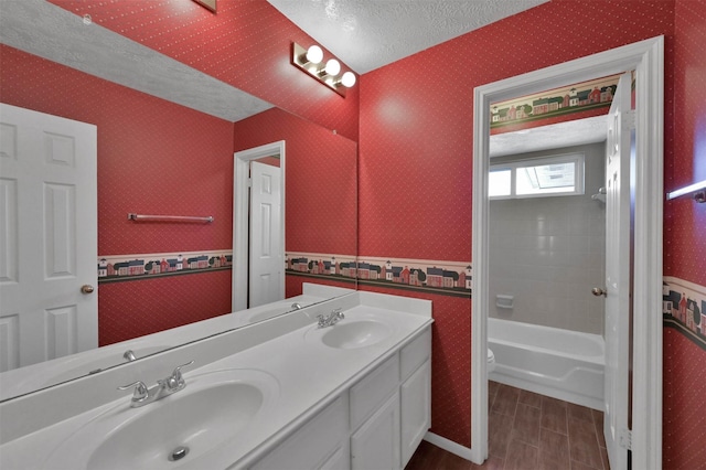 bathroom featuring vanity, toilet, and a textured ceiling