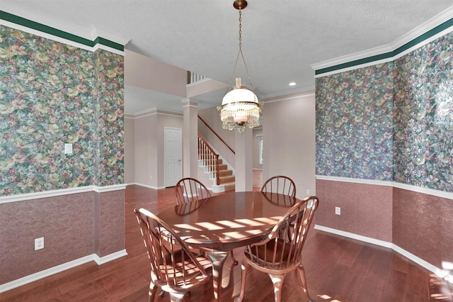 dining space featuring a textured ceiling, dark hardwood / wood-style floors, and crown molding