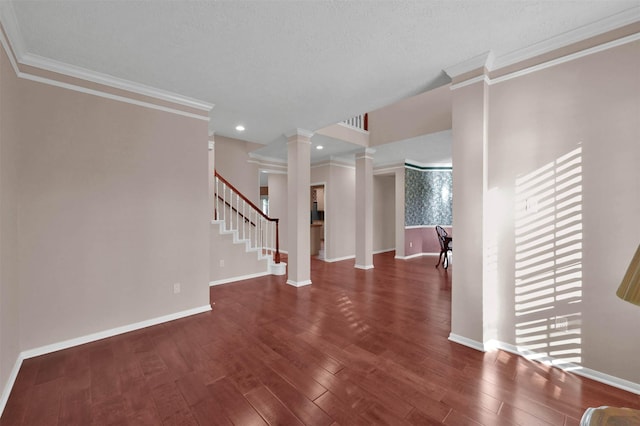 interior space with dark hardwood / wood-style floors, decorative columns, and crown molding