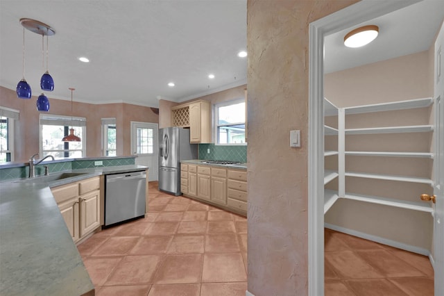 kitchen featuring appliances with stainless steel finishes, a wealth of natural light, pendant lighting, and sink