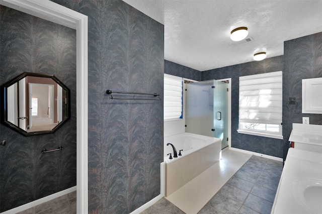 bathroom with tile patterned flooring, vanity, a textured ceiling, and shower with separate bathtub