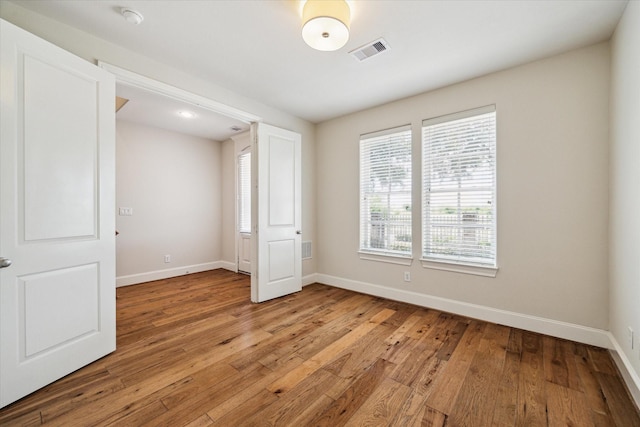 unfurnished bedroom with light wood-type flooring