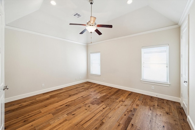 unfurnished room with hardwood / wood-style floors, plenty of natural light, crown molding, and vaulted ceiling