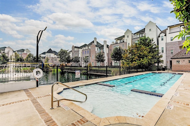 view of pool with a water view