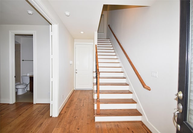 stairway featuring hardwood / wood-style flooring