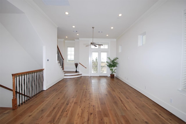 interior space with ceiling fan, hardwood / wood-style floors, french doors, and ornamental molding