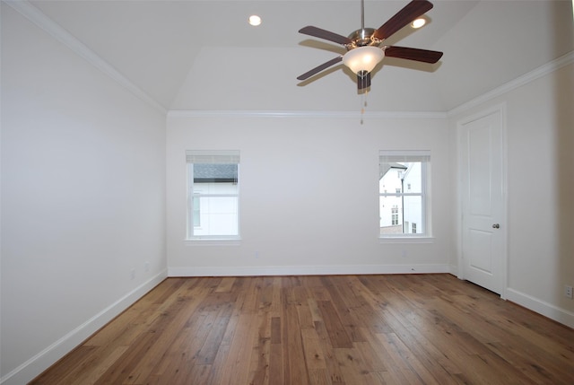 spare room with vaulted ceiling, a wealth of natural light, and crown molding