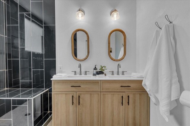1411 Clay St, Brenham, TX 77833 - bathroom featuring double vanity and tiled shower