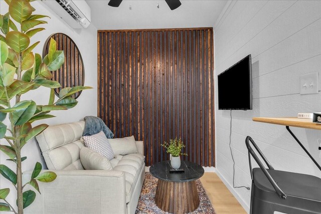 1411 Clay St, Brenham, TX 77833 - living area featuring ceiling fan, wood finished floors, and a wall unit AC