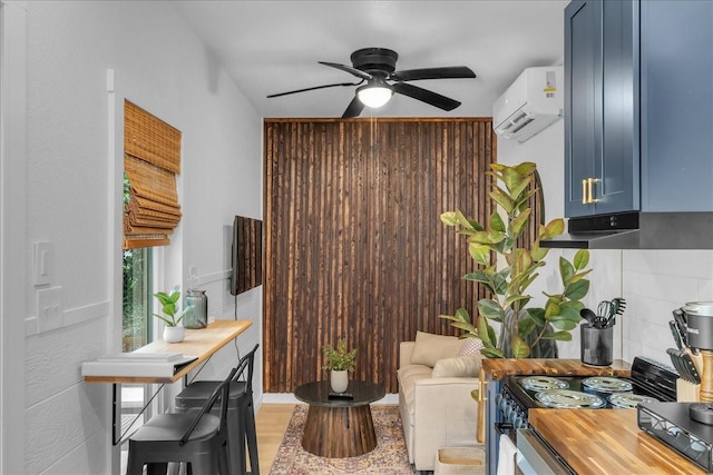 1411 Clay St, Brenham, TX 77833 - living area featuring a ceiling fan and an AC wall unit