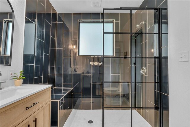 1411 Clay St, Brenham, TX 77833 - bathroom featuring vanity, a stall shower, and tile walls