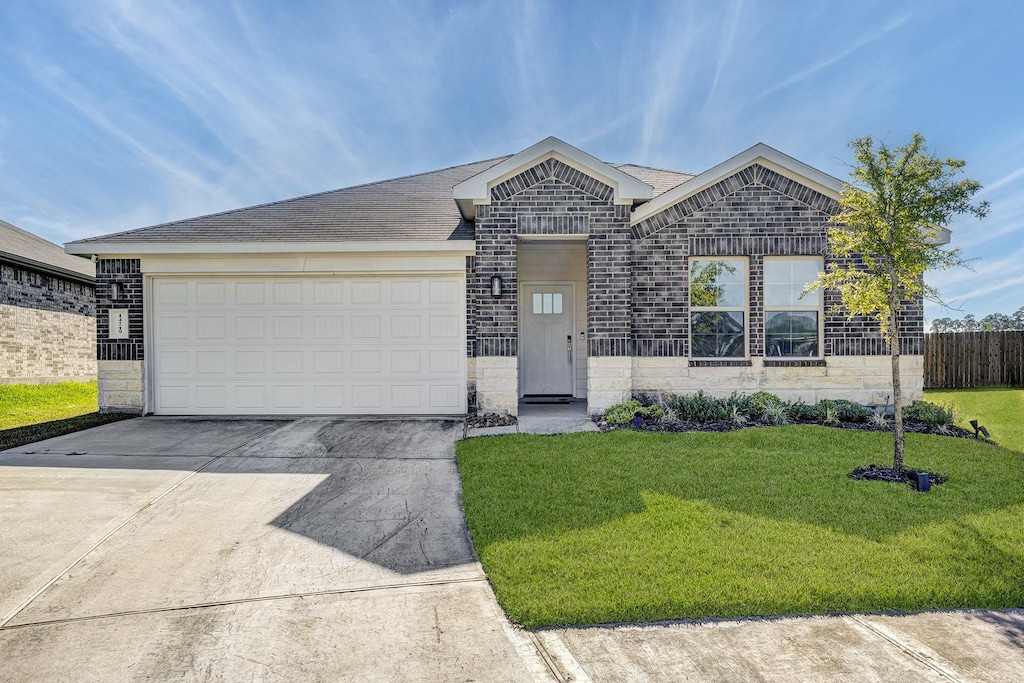 ranch-style house with a garage and a front yard