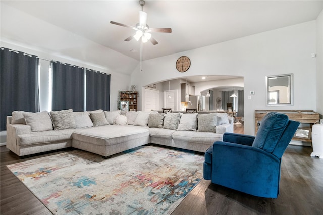 living room with high vaulted ceiling, ceiling fan, and dark wood-type flooring