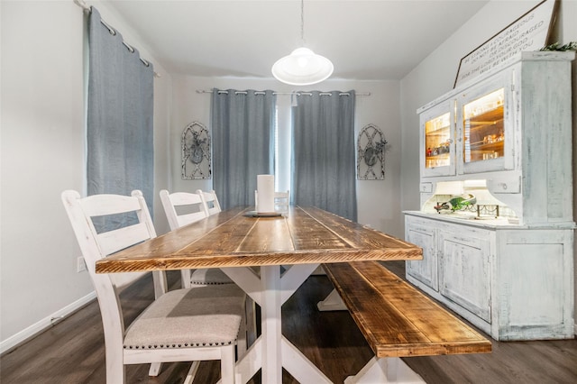 dining area with dark hardwood / wood-style floors