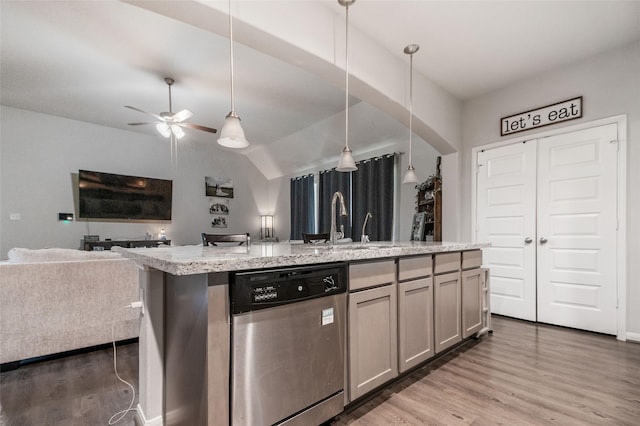 kitchen with dishwasher, lofted ceiling, ceiling fan, hanging light fixtures, and a center island with sink