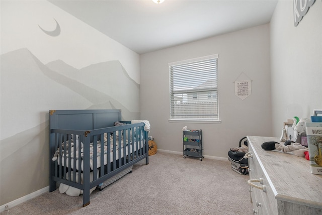 carpeted bedroom featuring a nursery area