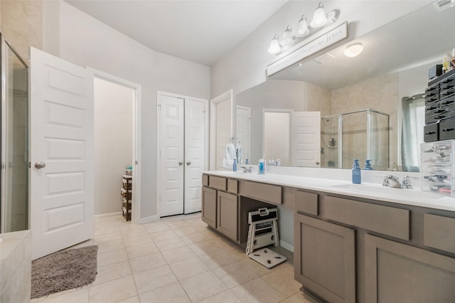 bathroom with tile patterned flooring, an enclosed shower, and vanity