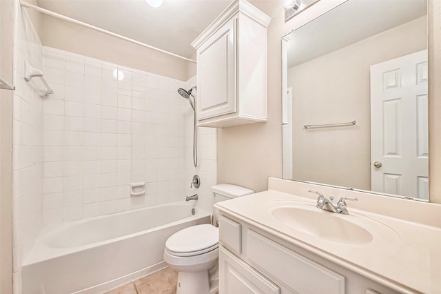 full bathroom featuring toilet, tile patterned flooring, vanity, and tiled shower / bath