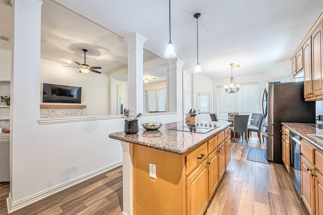 kitchen with ceiling fan with notable chandelier, light hardwood / wood-style flooring, ornate columns, a kitchen island, and stainless steel appliances