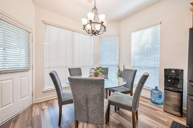 dining area featuring a chandelier and light wood-type flooring