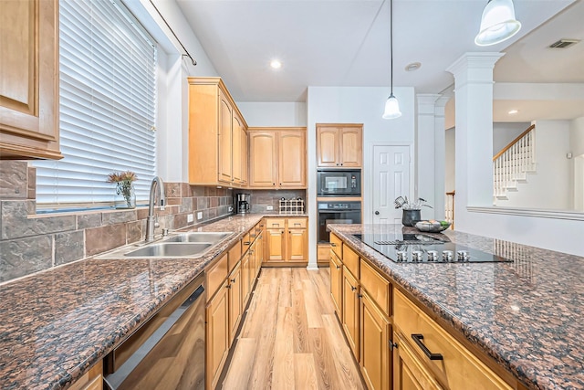 kitchen featuring backsplash, ornate columns, black appliances, sink, and hanging light fixtures