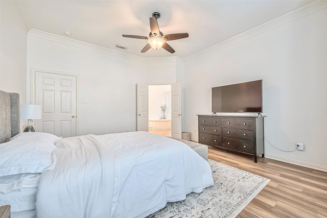 bedroom featuring ensuite bath, light hardwood / wood-style flooring, ceiling fan, and ornamental molding