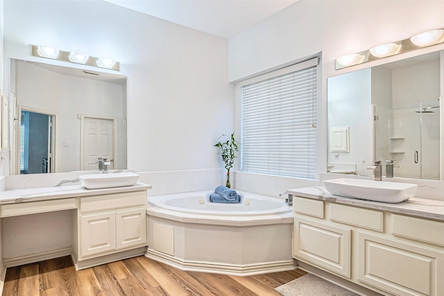 bathroom featuring vanity, independent shower and bath, and hardwood / wood-style flooring