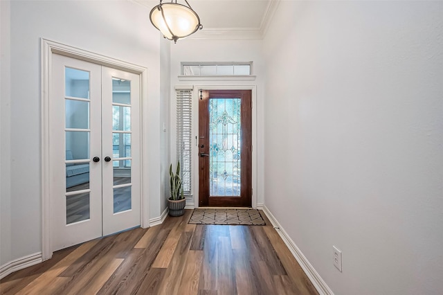 doorway to outside with dark hardwood / wood-style flooring, ornamental molding, and french doors