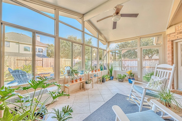 sunroom featuring vaulted ceiling with beams and ceiling fan