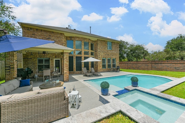 view of swimming pool featuring an in ground hot tub, a patio, an outdoor hangout area, and a grill