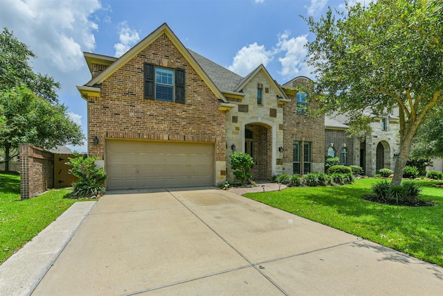 view of front of property with a garage and a front lawn