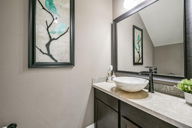 bathroom featuring vanity and vaulted ceiling