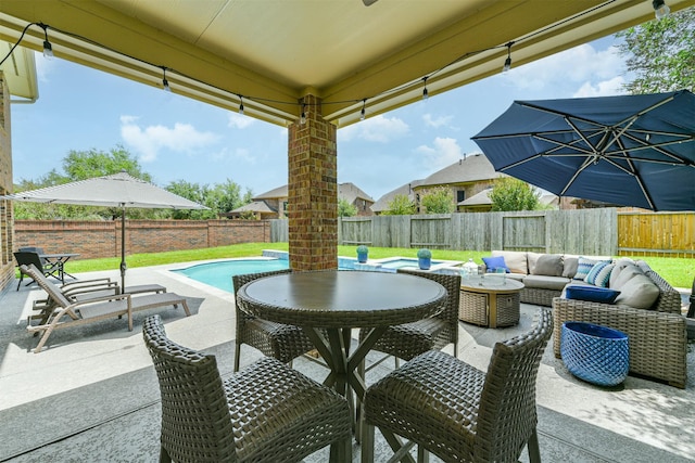 view of patio with outdoor lounge area and a fenced in pool