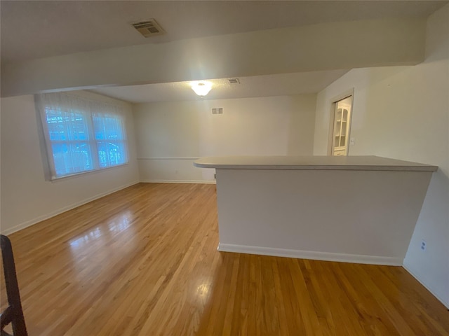 unfurnished living room with light hardwood / wood-style flooring