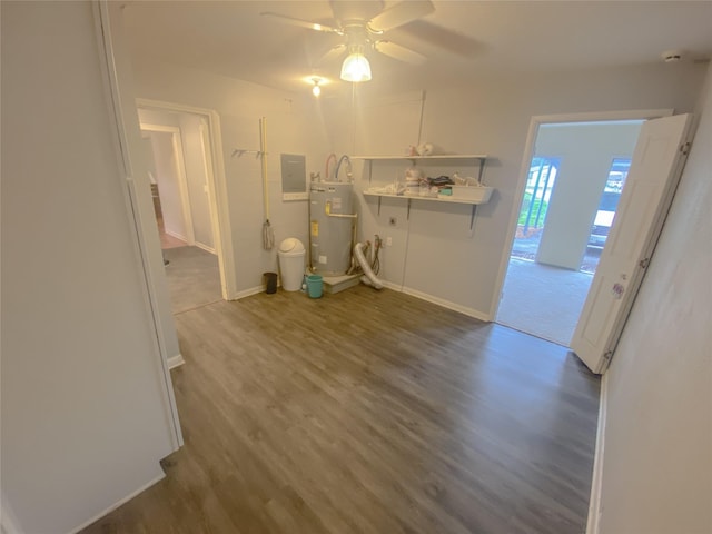 laundry area featuring water heater, dark wood finished floors, baseboards, and ceiling fan