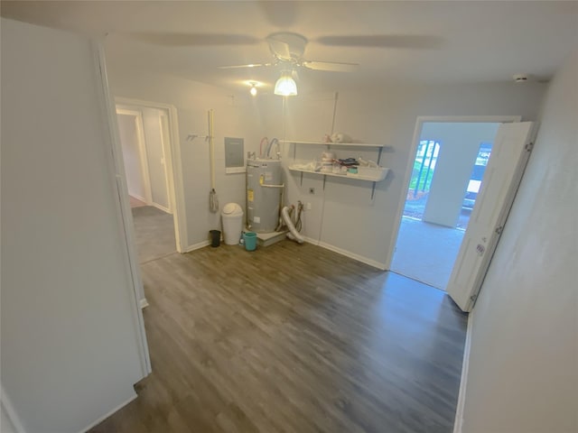 interior space featuring ceiling fan, baseboards, water heater, electric panel, and dark wood finished floors