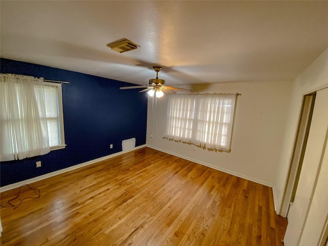 spare room with hardwood / wood-style flooring and ceiling fan