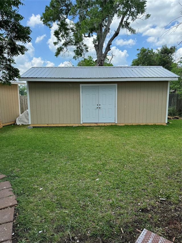 view of shed featuring fence